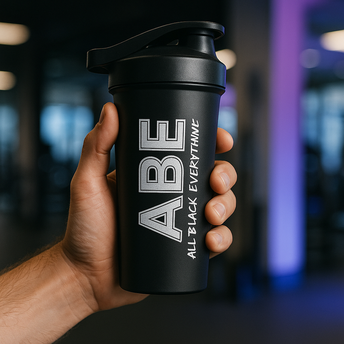 A close-up shot of the shaker being held by a hand in a bright, modern gym, with MSS accent colours as background blocks or light flares.