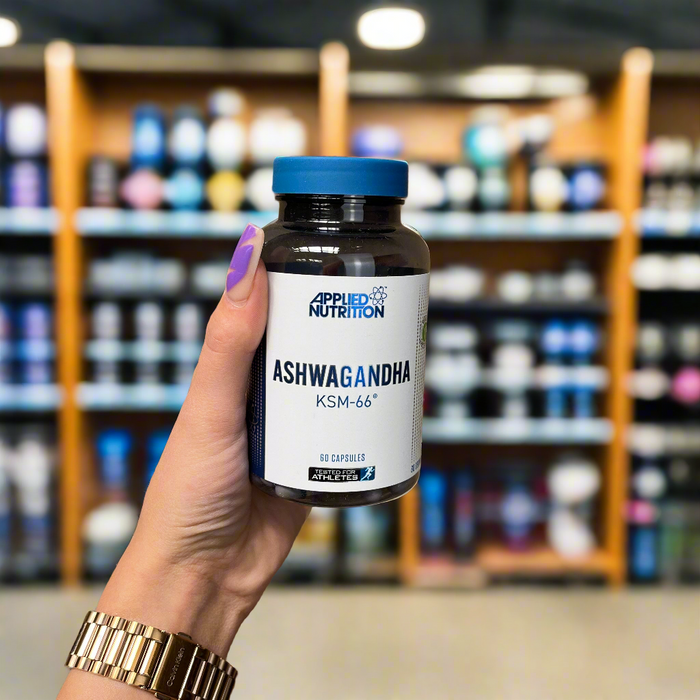 Close-up of (Applied Nutrition Ashwagandha KSM-66 - 60caps) held up inside My Supplement Shop, clearly showing the front label in a Sports Nutrition setting.