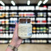 Close-up of (Grenade Protein Spread 360g) held up inside My Supplement Shop, clearly showing key ingredients on the packaging in a Sports Nutrition setting.