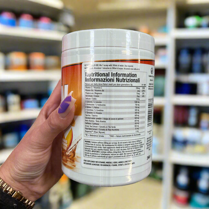 Close-up of (Per4m Amino Burn 240g) held up inside My Supplement Shop, clearly showing Nutritional Values on the packaging in a Sports Nutrition setting.